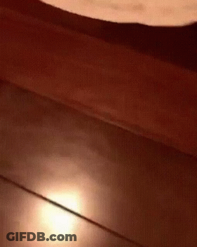 A Close Up Of A Wooden Floor With A Light Shining On It GIF