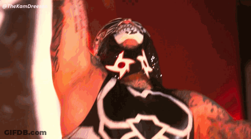 A Close Up Of A Wrestler 'S Face With A Mask On His Face GIF