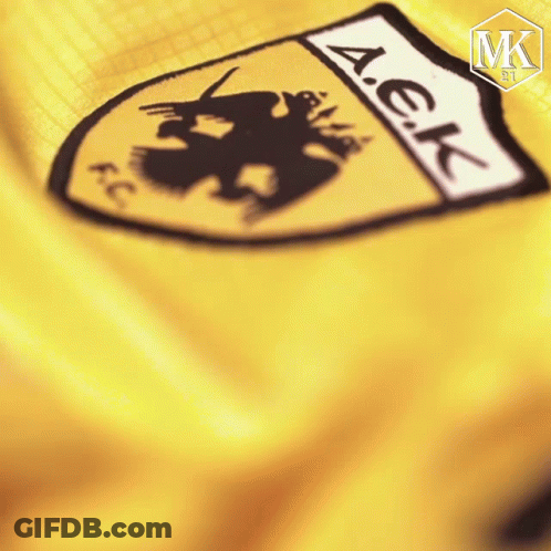 A Close Up Of A Yellow A.e.k. Emblem GIF