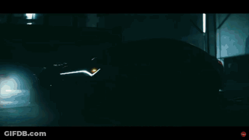 A Close Up Of A Yellow Acura Car With A Red Headlight GIF