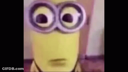 A Close Up Of A Yellow Minion Wearing Glasses . GIF