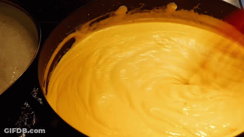 A Close Up Of A Yellow Sauce In A Pan GIF