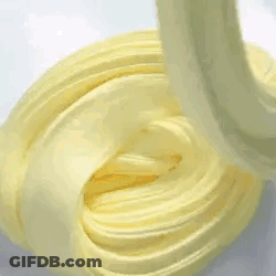 A Close Up Of A Yellow Swirl Of Slime On A Table . GIF