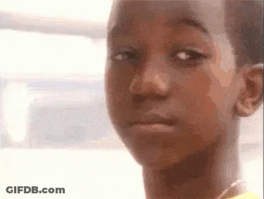 A Close Up Of A Young Boy Making A Funny Face . GIF