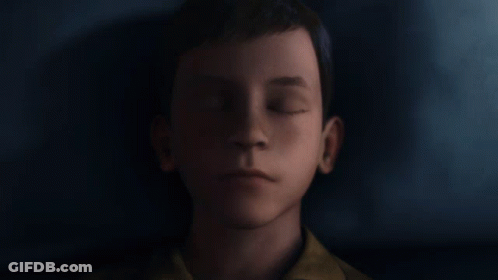 A Close Up Of A Young Boy 'S Face Against A Dark Background GIF