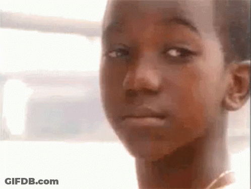 A Close Up Of A Young Boy 'S Face With A Sad Look On His Face . GIF