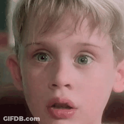 A Close Up Of A Young Boy 'S Face With His Mouth Open . GIF
