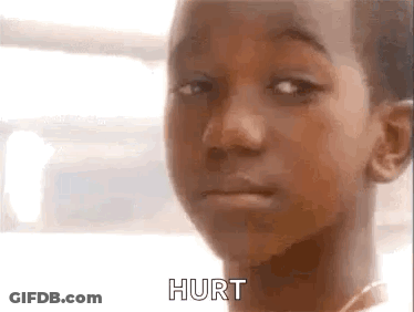 A Close Up Of A Young Boy 'S Face With The Words Hurt Written On It . GIF