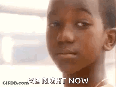A Close Up Of A Young Boy 'S Face With The Words `` Me Right Now '' Written On It . GIF