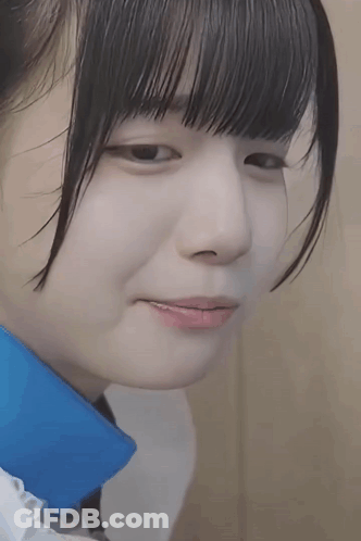 A Close Up Of A Young Girl 'S Face With A Blue Collar . GIF