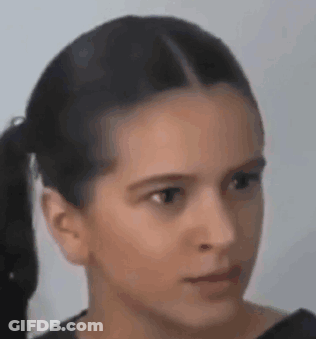 A Close Up Of A Young Girl 'S Face With A Ponytail . GIF