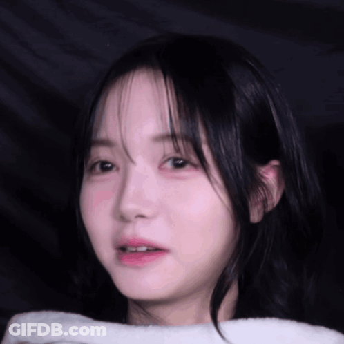 A Close Up Of A Young Girl 'S Face With A White Towel Around Her Neck GIF