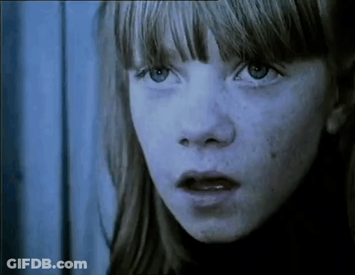 A Close Up Of A Young Girl 'S Face With Freckles . GIF