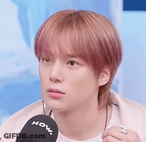 A Close Up Of A Young Man Holding A Microphone . GIF