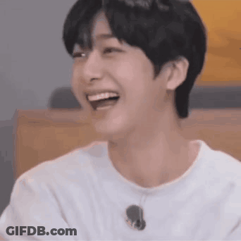 A Close Up Of A Young Man Laughing With His Mouth Open . GIF