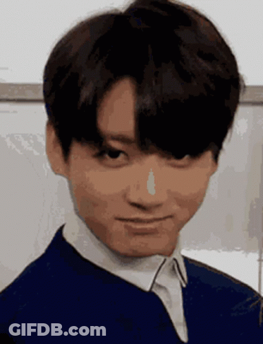 A Close Up Of A Young Man Making A Funny Face While Wearing A Blue Jacket And White Shirt . GIF