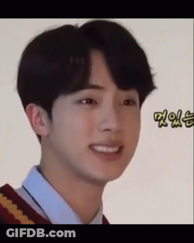 A Close Up Of A Young Man Making A Funny Face While Wearing A Sweater And A Shirt . GIF