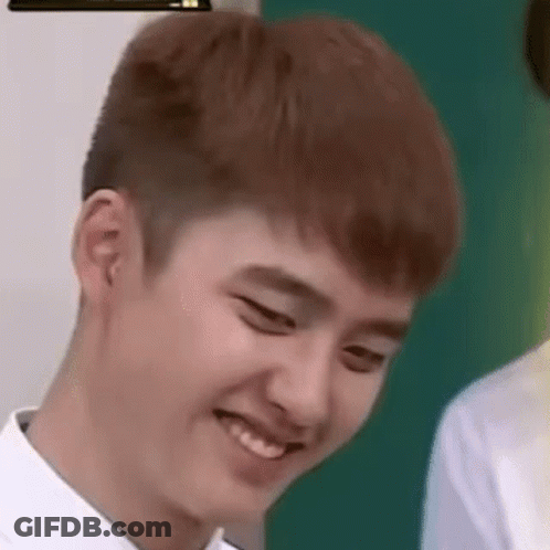 A Close Up Of A Young Man Making A Funny Face While Wearing A White Shirt . GIF