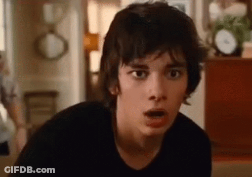 A Close Up Of A Young Man Making A Surprised Face In A Living Room . GIF