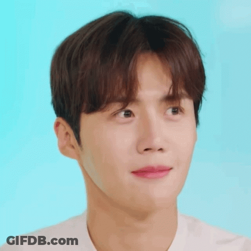 A Close Up Of A Young Man 'S Face Against A Blue Background GIF