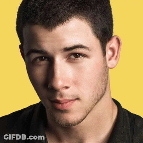 A Close Up Of A Young Man 'S Face Against A Yellow Background GIF