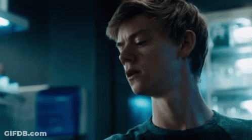 A Close Up Of A Young Man 'S Face In A Dark Room . GIF