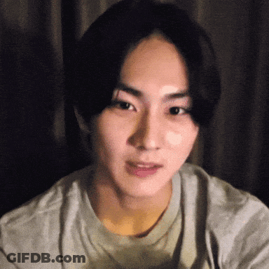 A Close Up Of A Young Man 'S Face In A Grey Shirt GIF