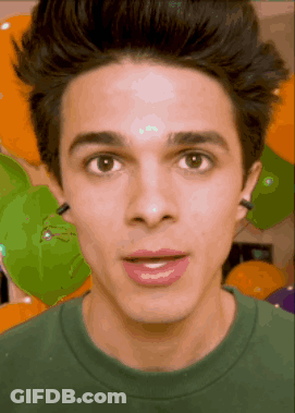 A Close Up Of A Young Man 'S Face In Front Of Balloons GIF