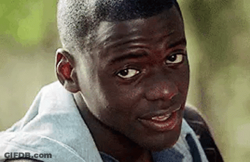 A Close Up Of A Young Man 'S Face Looking At The Camera . GIF