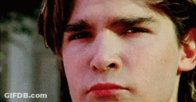 A Close Up Of A Young Man 'S Face Making A Funny Face . GIF