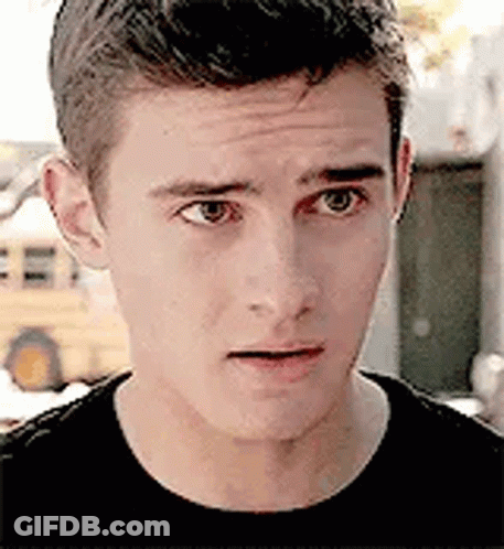 A Close Up Of A Young Man 'S Face Making A Funny Face . GIF
