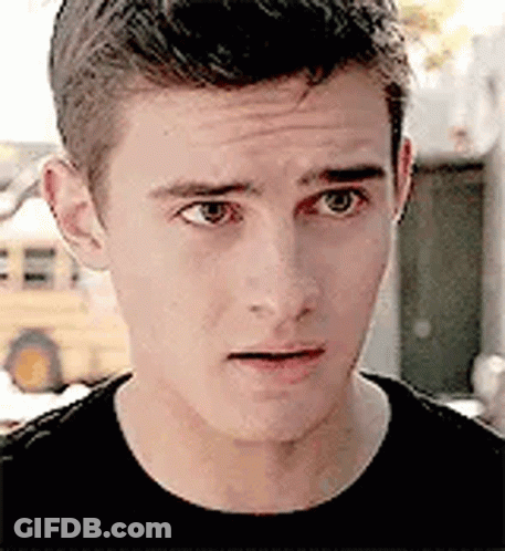 A Close Up Of A Young Man 'S Face Making A Funny Face . GIF