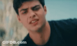 A Close Up Of A Young Man 'S Face Making A Funny Face . GIF