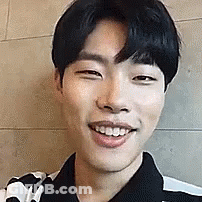 A Close Up Of A Young Man 'S Face Smiling . GIF
