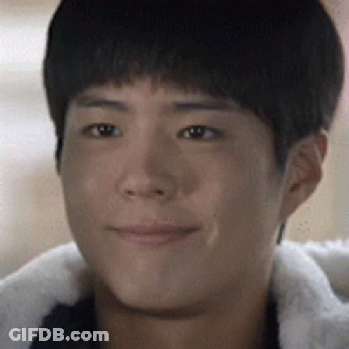 A Close Up Of A Young Man 'S Face Wearing A Fur Jacket GIF