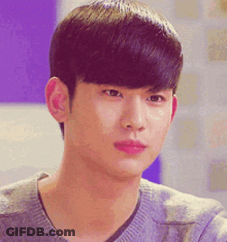 A Close Up Of A Young Man 'S Face Wearing A Gray Sweater GIF