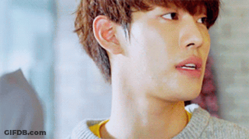 A Close Up Of A Young Man 'S Face Wearing A Grey Sweater GIF