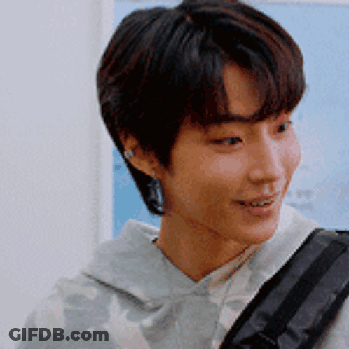 A Close Up Of A Young Man 'S Face With A Backpack GIF