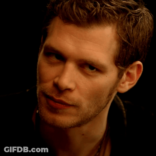 A Close Up Of A Young Man 'S Face With A Black Background GIF