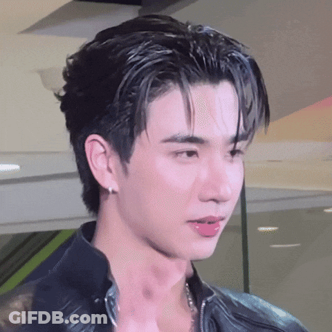 A Close Up Of A Young Man 'S Face With A Black Jacket On . GIF