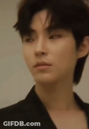 A Close Up Of A Young Man 'S Face With A Black Jacket On . GIF