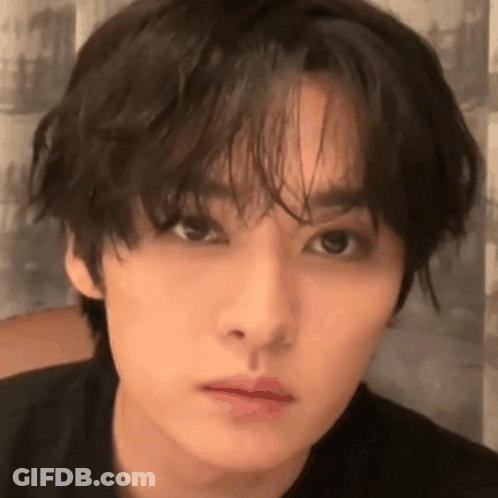 A Close Up Of A Young Man 'S Face With A Black Shirt On . GIF