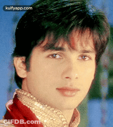 A Close Up Of A Young Man 'S Face With A Blue Background GIF