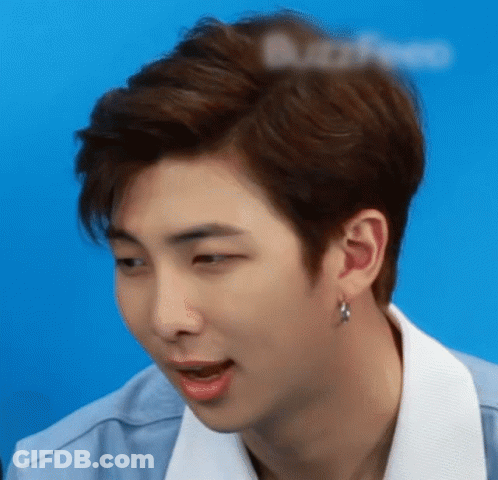 A Close Up Of A Young Man 'S Face With A Blue Background GIF