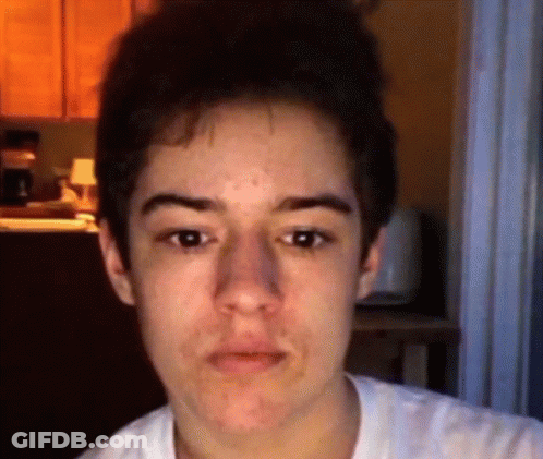 A Close Up Of A Young Man 'S Face With A Blurred Background GIF