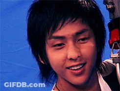 A Close Up Of A Young Man 'S Face With A Camera In The Background GIF