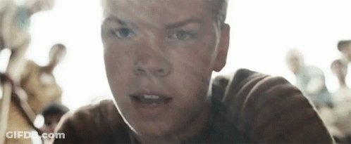 A Close Up Of A Young Man 'S Face With A Crowd Of People Behind Him . GIF