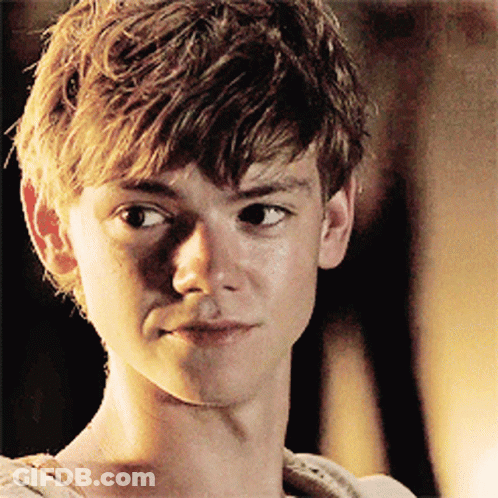A Close Up Of A Young Man 'S Face With A Dark Background GIF