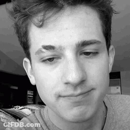 A Close Up Of A Young Man 'S Face With A Gray Shirt On GIF