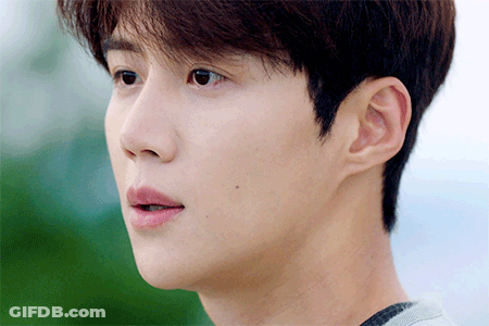 A Close Up Of A Young Man 'S Face With A Gray Shirt On GIF